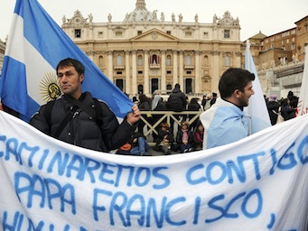 A man holds an Argentine flag as he awaits blessing of newly elected Pope Francis in St. Peter's Square in the Vatican