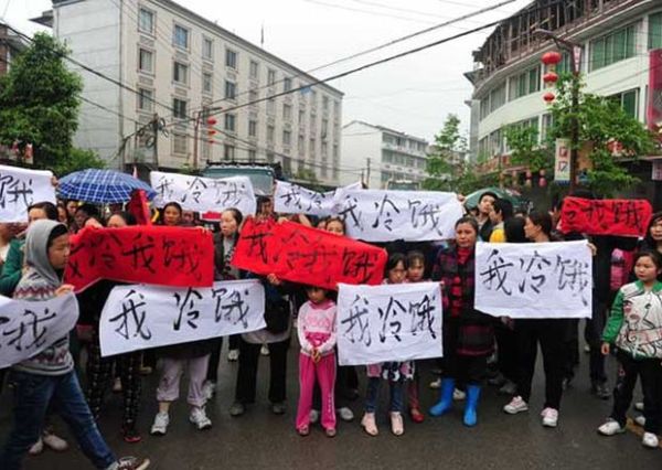 Habitantes de Lingguan en Baoxing salieron a las calles con carteles que decían "Tenemos hambre y frío".