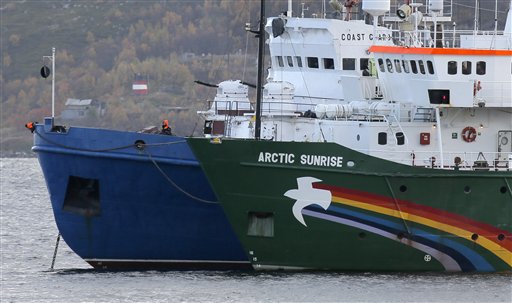 El barco Arctic Sunrice de Greenpeace, a la derecha, permanece detenido en una pequeña bahía cerca de Severomorsk, Rusia, el martes 24 de septiembre de 2013. Según las autoridades rusas, activistas de Greenpeace intentaron subir a una plataforma petrolífera en el Artico. (AP Foto/Efrem Lukatsky)