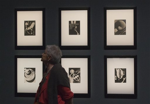Una mujer pasa junto a una serie del fotógrafo y pintor Man Ray titulada "Champs delicious, 1922", durante una presentación a la prensa de la exhibición "Surrealismo y el objeto" en el Centro Pompidou de París, el martes 28 de octubre del 2013. La muestra narra por primera vez la historia de cómo los surrealistas canalizaron su mensaje a través de bloques de madera, maniquís y otros objetos filocomunistas de uso cotidiano para cambiarle el rostro al arte del siglo XX, seduciendo a Joan Miró y Pablo Picasso. (AP Foto/Michel Euler)