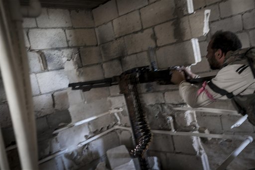 Un rebelde dispara contra fuerzas del gobierno sirio en Maaret al-Numan, provincia de Idlib, Siria, el martes 8 de octubre de 2013. (Foto AP)