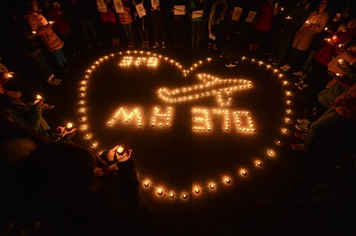 En esta foto del 13 de marzo de 2014, estudiantes realizan una vigilia con velas por los pasajeros del vuelo desaparecido de Malaysia Airlines MH370 en Yangzhou, China. (AP Foto) CHINA OUT