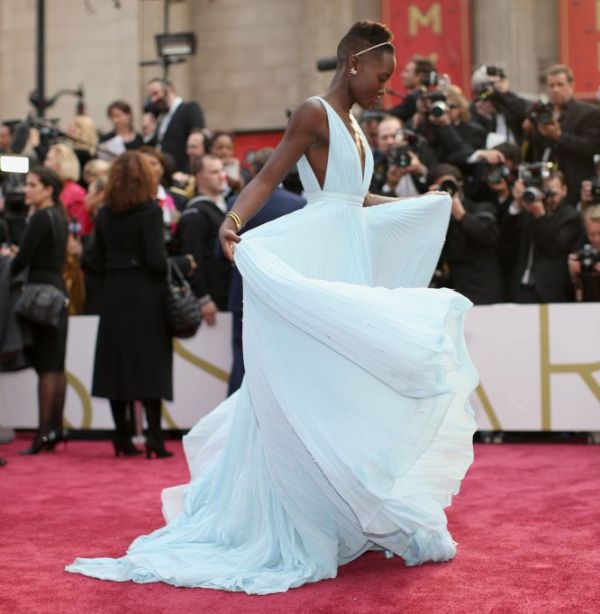La actriz Lupita Nyong'o, nominada a mejor actriz de reparto por '12 años de esclavitud', avanza por la alfombra roja con su Prada.