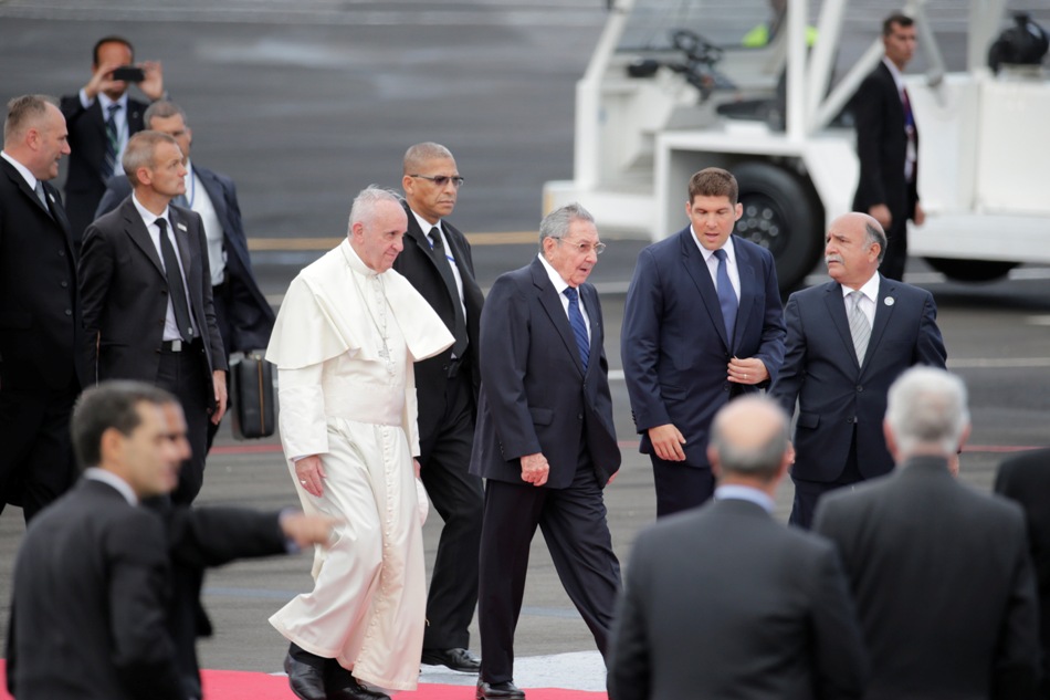 Rodeado de agentes de seguridad, el papa Francisco camina con el presidente cubano Raúl Castro al llegar a La Habana, Cuba, el sábado 19 de septiembre de 2015. El papa Francisco inicia su viaje de diez días a Cuba y Estados Unidos el sábado, embarcándose en su primer viaje a los países alguna vez rivales de la Guerra Fría para animar su histórica reconciliación. (Foto AP/Ramón Espinosa)