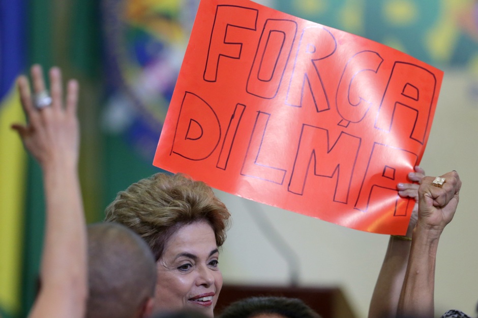 La presidenta brasileña Dilma Rousseff pasa junto a un leterro que dice "Fuerza Dilma" en portugués durante la ceremonia del Programa de Lanzamiento de Nuevas Universidades Federales en el Palacio Presidencial de Planalto, en Brasilia, el lunes 9 de mayo de 2016. (Foto AP/Eraldo Peres)