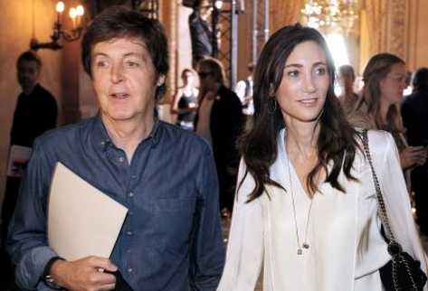 British singer Paul McCartney (L) holds hands with partner Nancy Shevell (L) during Stella McCartney Spring/Summer 2012 ready-to-wear collection show, on October 3, 2011 in Paris. AFP PHOTO/PATRICK KOVARIK