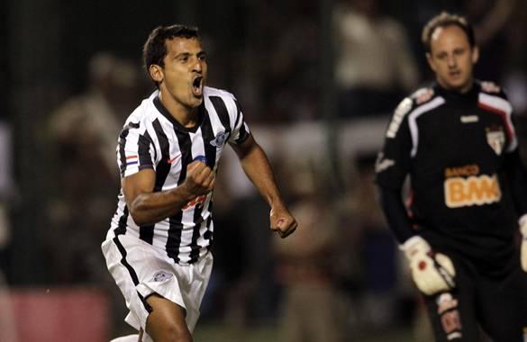 Sergio Aquino of Paraguay's Libertad celebrates after scoring in front of Brazil's Sao Paulo goalie Rogerio Ceni during a Copa Sudamericana soccer match in Asuncion