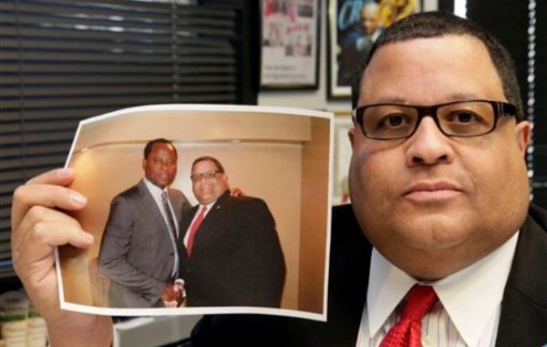 Louis Perry, presidente de Kadima Security Services en su oficina con una fotografía de él y del médico Conrad Murray en Los Angeles el viernes 11 de noviembre de201. Perry trabajó como chofer de Murray durante el juicio en su contra por la muerte de Michael Jackson y dijo que el doctor recibió muchos favores del equipo de producción de un documental sobre él y el cantante. (Foto AP/Nick Ut)