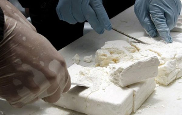 A member of Colombia's Navy checks cocaine seized in the Gulf of Morrosquillo, in Cartagena