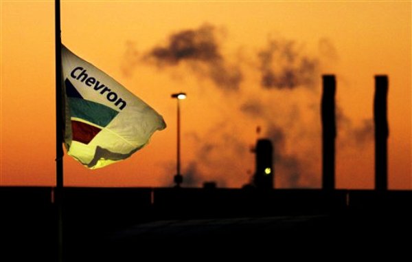 **FILE** Smoke billows from a ChevronTexaco refinery in Richmond, Calif. in this file photo from Tuesday, July 26, 2005. Chevron Corp. shares fell after the company cautioned its fourth-quarter profit will be hurt by lower crude oil prices, declining production and weaker margins in its refining business. (AP Photo/Noah Berger, File)