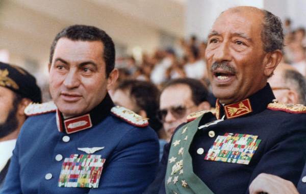 Egyptian vice President, Gen. Hosni Mubarak (L) and late President Anwar Sadat (R), both dressed in military honour uniforms, attend a military parade, 06 October 1981, in Cairo, commemorating Victory Day. Moments after, a group of military Islamist fundamentalists with allegiance to the Al-Jihad group killed Sadat in a shooting spree. Following Sadat's assassination Mubarak was sworn in as Egypt?s fourth president, a position of power he has since retained, being re-elected five times. AFP PHOTO/- (Photo credit should read AFP PHOTO/AFP/Getty Images)