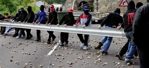 Un grupo de mineros usa una barra ferroviaria para bloquear una carretera como protesta en Cinera, cerca de León, España, el lunes 11 de junio del 2012. Las huelgas, bloqueos de caminos y sentadas en las minas continuaban mientras 8.000 mineros de 40 minas de carbón del norte de España protestaban por los recortes de subsidios anunciados por el gobierno debido a la crisis económica. (Foto AP/Juan Manuel Serrano)