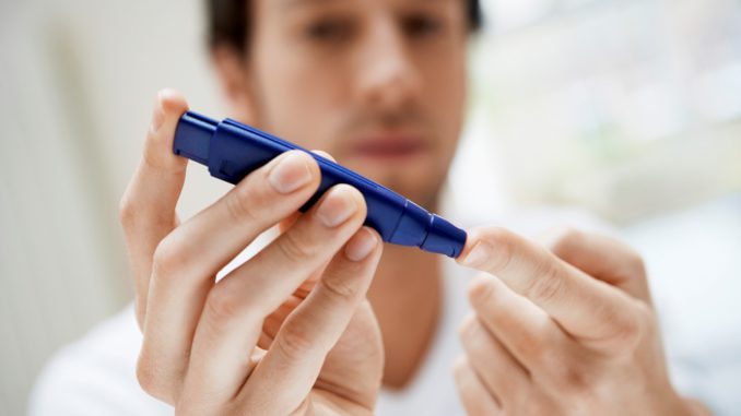 Man Performing Blood Test on Himself