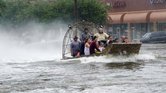 People are rescued from flood waters from Hurricane Harvey on an air boat in Dickinson