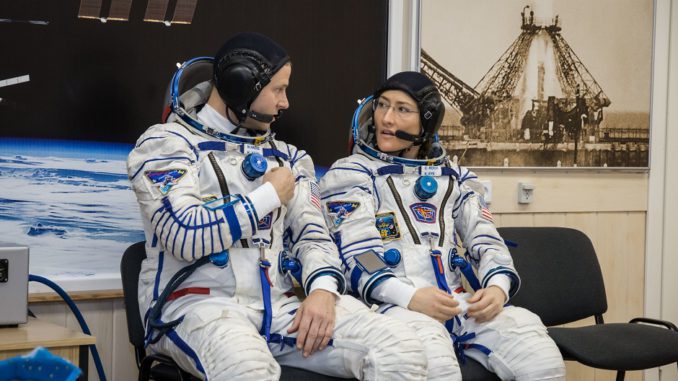 jsc2019e009948 - At the Baikonur Cosmodrome in Kazakhstan, Expedition 59 crewmembers Nick Hague (left) and Christina Koch (right) of NASA discuss procedures Feb. 27 during a Soyuz fit check dress rehearsal that is part of pre-launch training. Hague, Koch