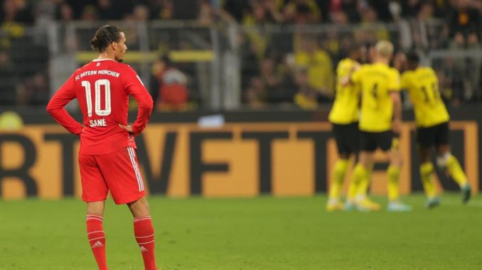 Dortmund (Germany), 08/10/2022.- Bayern's Leroy Sane reacts as Dortmund players celebrate their 2-2 equalizer during the German Bundesliga soccer match between Borussia Dortmund and Bayern Munich in Dortmund, Germany, 08 October 2022. (Alemania, Rusia) EFE/EPA/FRIEDEMANN VOGEL CONDITIONS - ATTENTION: The DFL regulations prohibit any use of photographs as image sequences and/or quasi-video.