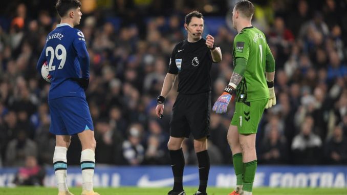 London (United Kingdom), 18/03/2023.- Chelsea's Kai Havertz (L) holds the ball before to execute a penalty shot as Everton goalkeeper Jordan Pickford (R) argues with referee Darren England (C) during the English Premier League soccer match between Chelsea and Everton in London, Britain, 18 March 2023. (Jordania, Reino Unido, Londres) EFE/EPA/Daniel Hambury EDITORIAL USE ONLY. No use with unauthorized audio, video, data, fixture lists, club/league logos or 'live' services. Online in-match use limited to 120 images, no video emulation. No use in betting, games or single club/league/player publications