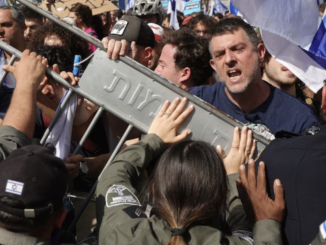Police hold back demonstrators blocking the Ayalon Road in Tel Aviv's city center on Wednesday. (Abir Sultan/EPA-EFE/Shutterstock)