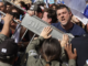 Police hold back demonstrators blocking the Ayalon Road in Tel Aviv's city center on Wednesday. (Abir Sultan/EPA-EFE/Shutterstock)
