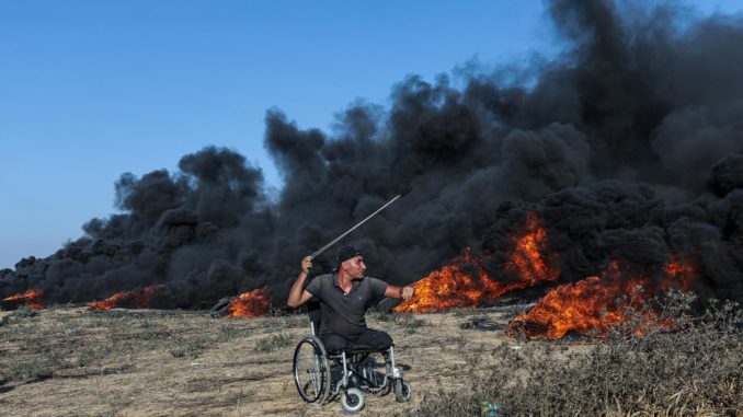 Clashes erupt between Palestinians and Israeli troops at Gaza Strip border