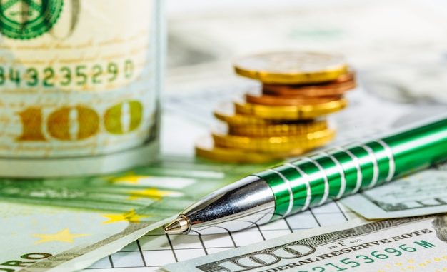 american-dollars-euro-banknotes-coins-ballpoint-pen-bills-money-currency-background-with-money-dollar_116317-2095